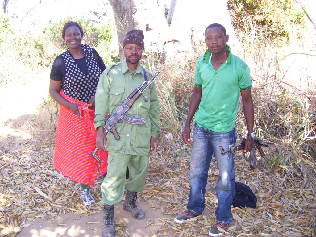 Armed game scouts resting in the bush